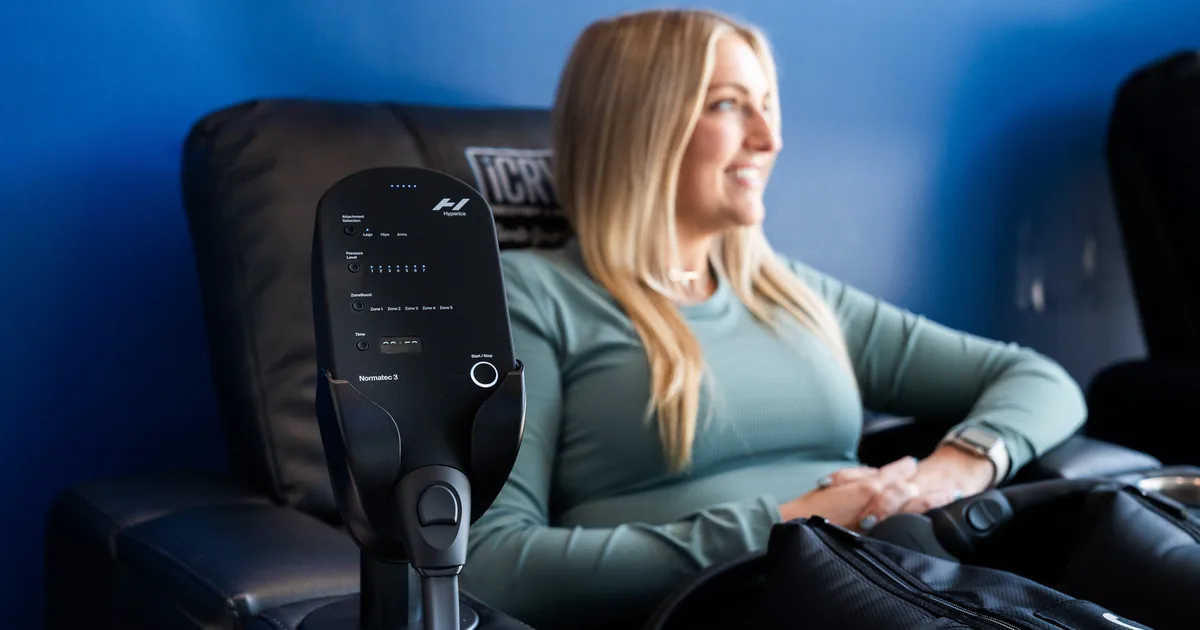 Runner relaxing during compression therapy for recovery at iCRYO South Jordan