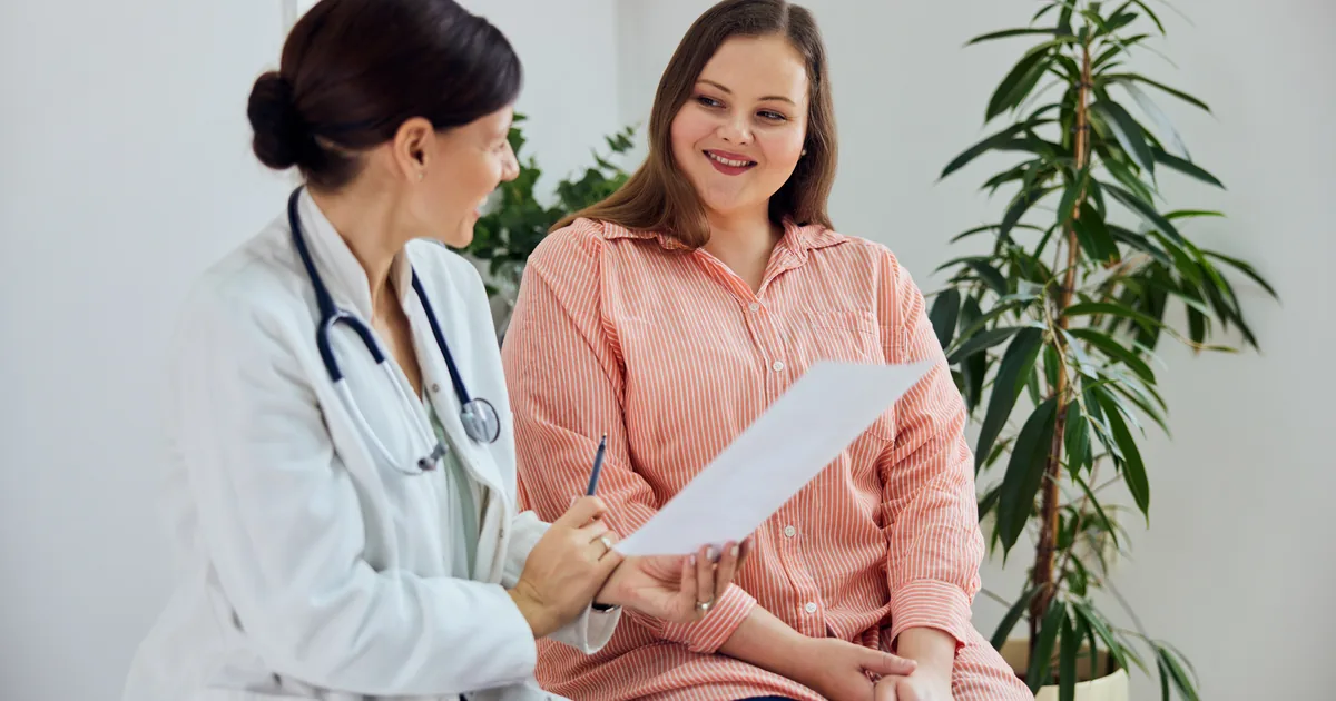 Provider measuring a patient's waist during a medical weight loss consultation at iCRYO South Jordan